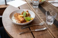 Bowl of food on wooden table